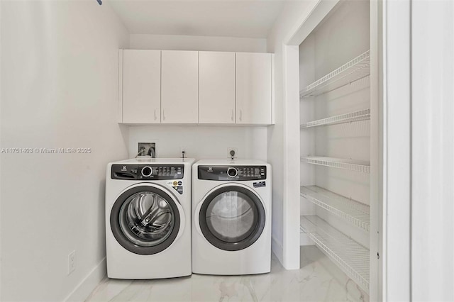 laundry room with baseboards, marble finish floor, cabinet space, and washer and dryer