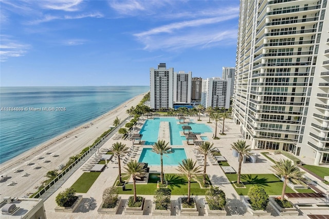 bird's eye view with a water view, a city view, and a view of the beach
