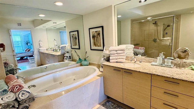 bathroom with two vanities, a shower stall, visible vents, a sink, and a whirlpool tub