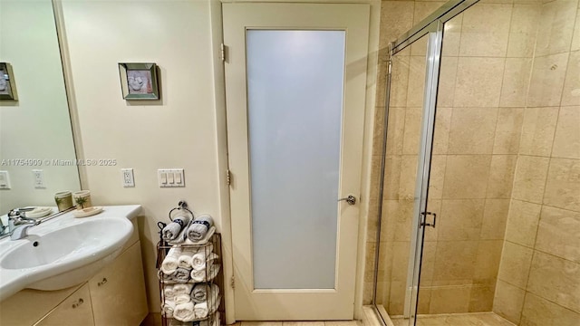 bathroom featuring a shower stall and vanity
