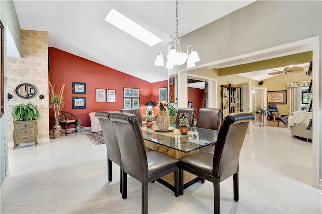 dining space featuring a skylight, light tile patterned floors, high vaulted ceiling, and ceiling fan with notable chandelier