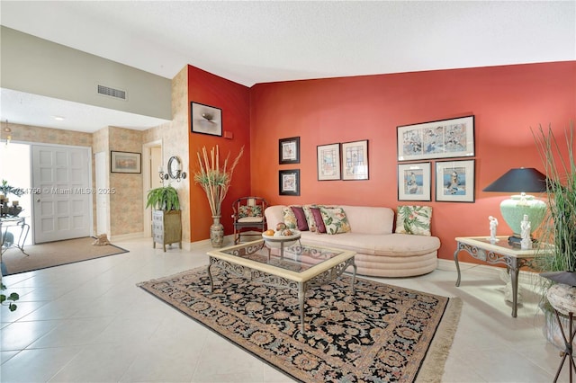 tiled living room featuring lofted ceiling, a textured ceiling, visible vents, and baseboards