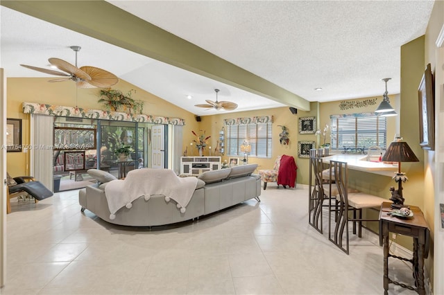 tiled living room with a healthy amount of sunlight, ceiling fan, and lofted ceiling with beams