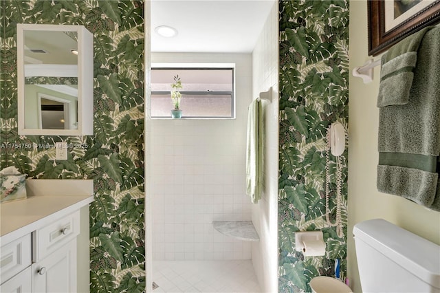 bathroom featuring walk in shower, vanity, toilet, and wallpapered walls