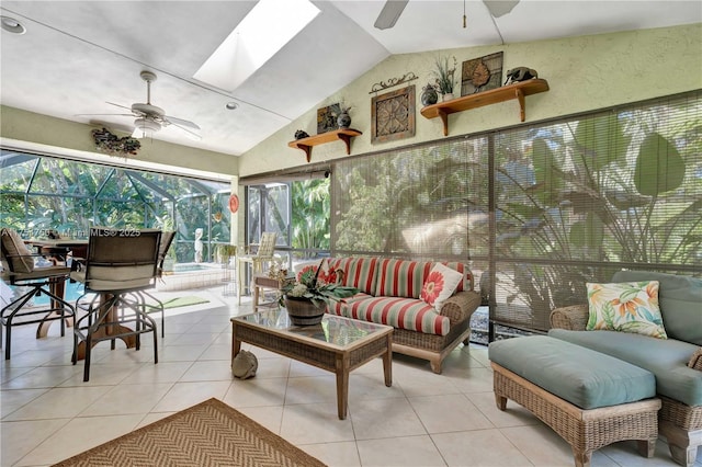 sunroom featuring lofted ceiling with skylight and a ceiling fan