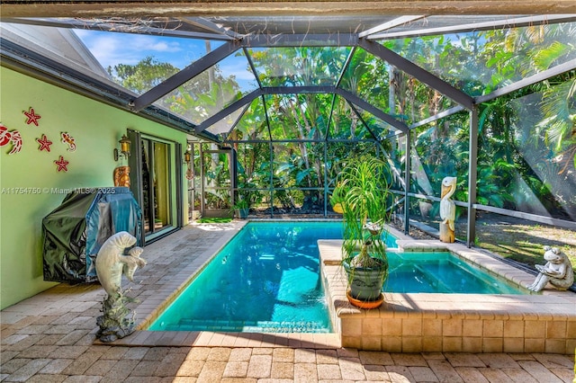 pool with a patio, grilling area, and a lanai