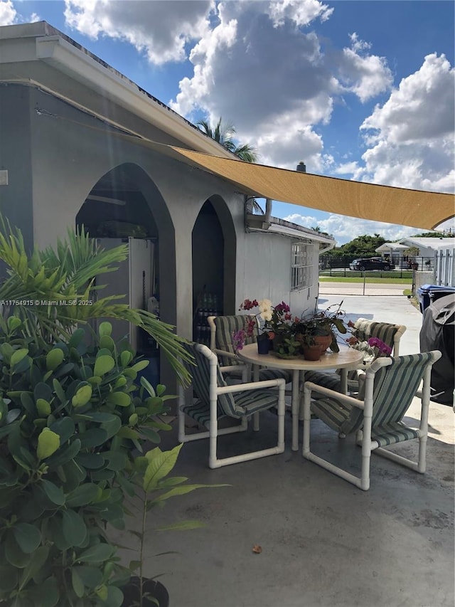 view of patio with outdoor dining area and fence