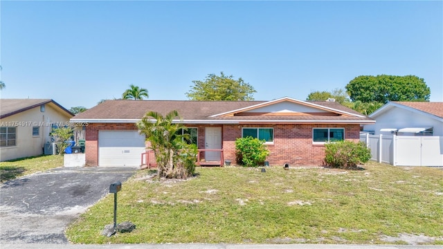 ranch-style house featuring aphalt driveway, cooling unit, brick siding, and an attached garage