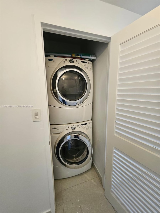 washroom featuring stacked washing maching and dryer and laundry area