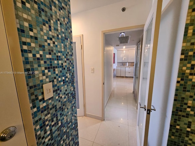 bathroom featuring tile patterned flooring, visible vents, and baseboards