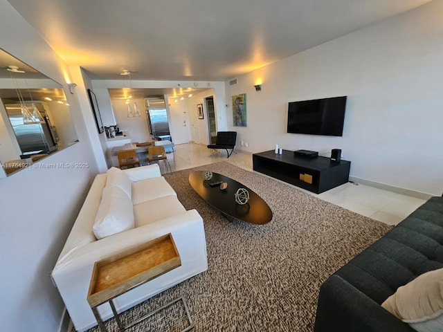 tiled living area featuring baseboards