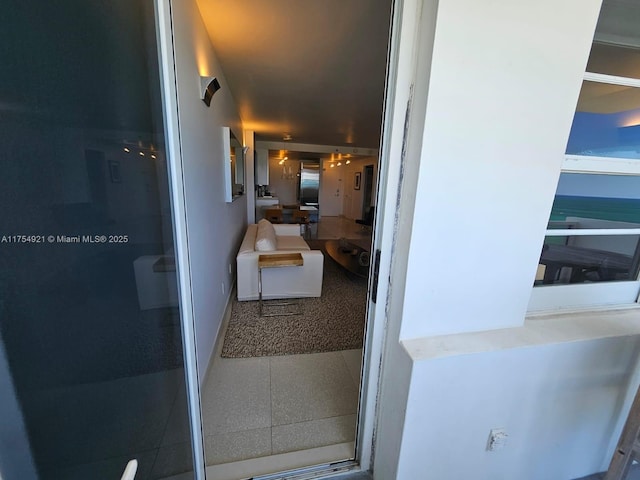 hallway with tile patterned flooring