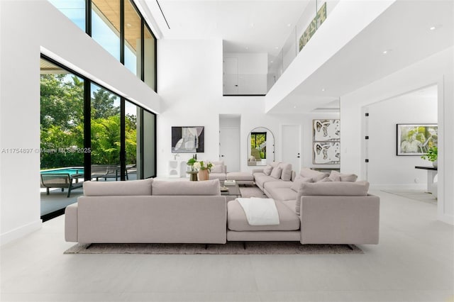 4425 Adams Ave, Miami Beach, FL 33140 - living area with a towering ceiling, healthy amount of natural light, and baseboards