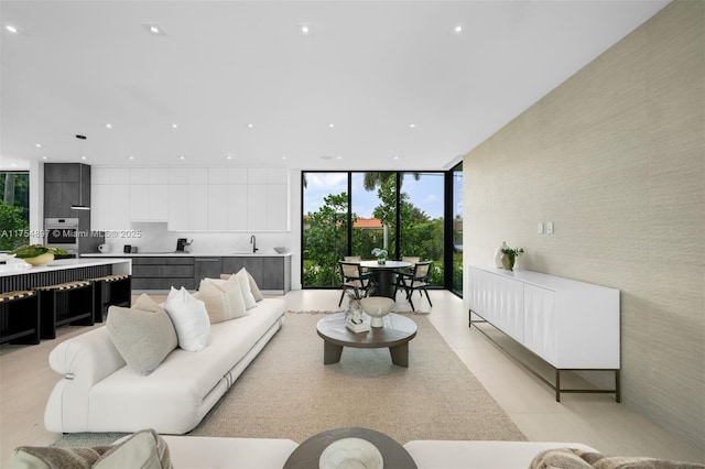 living room featuring a wall of windows and recessed lighting