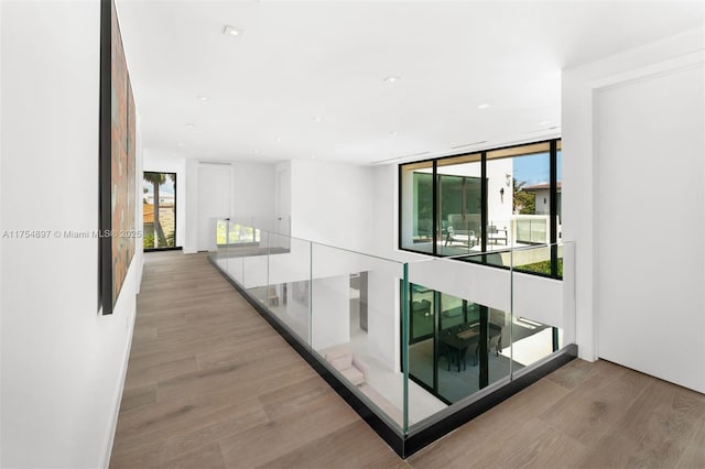 4425 Adams Ave, Miami Beach, FL 33140 - corridor featuring healthy amount of natural light, light wood-type flooring, and a wall of windows