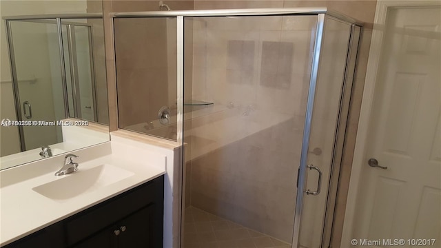 full bathroom with a stall shower and vanity