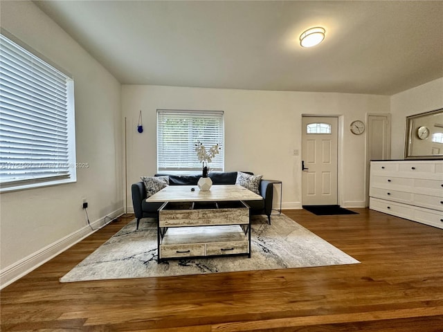 dining space with baseboards and wood finished floors