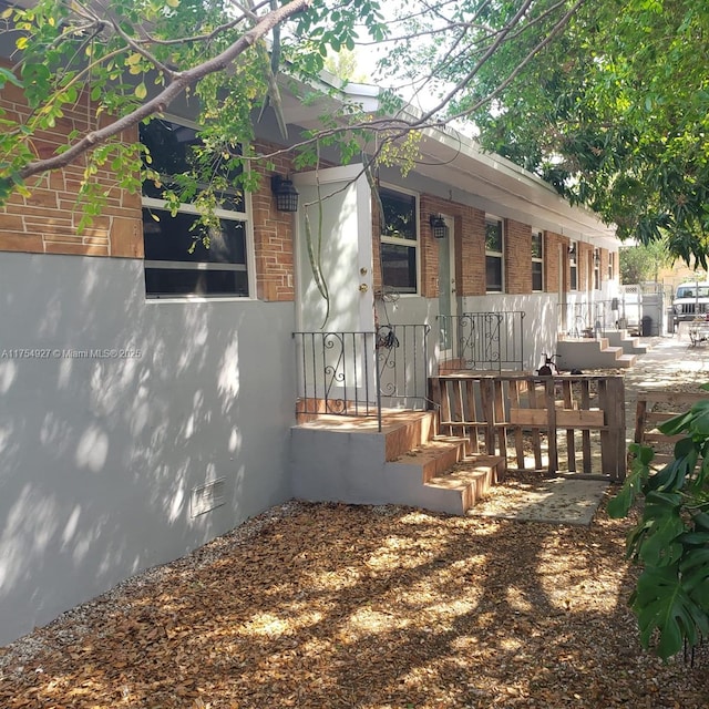 view of property exterior with crawl space and brick siding