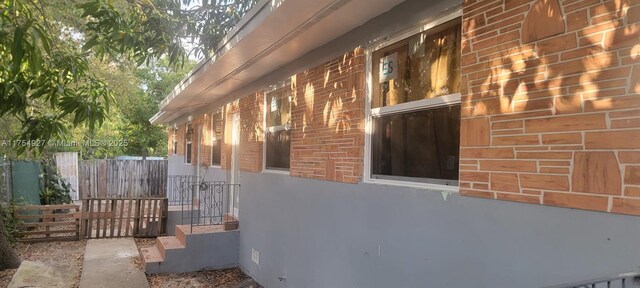 view of property exterior with brick siding