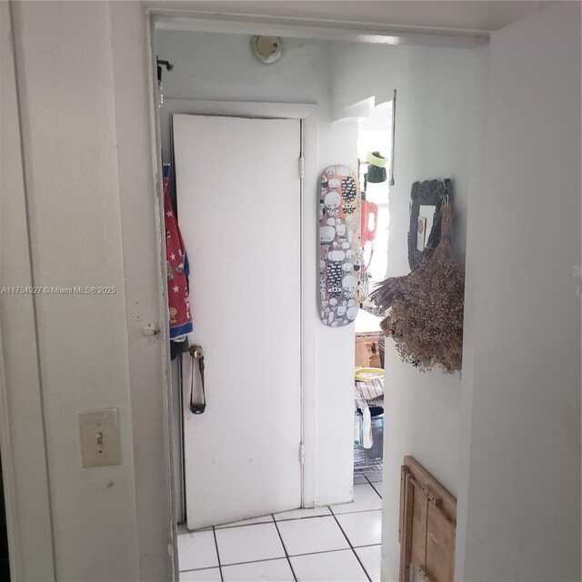 hall featuring light tile patterned flooring