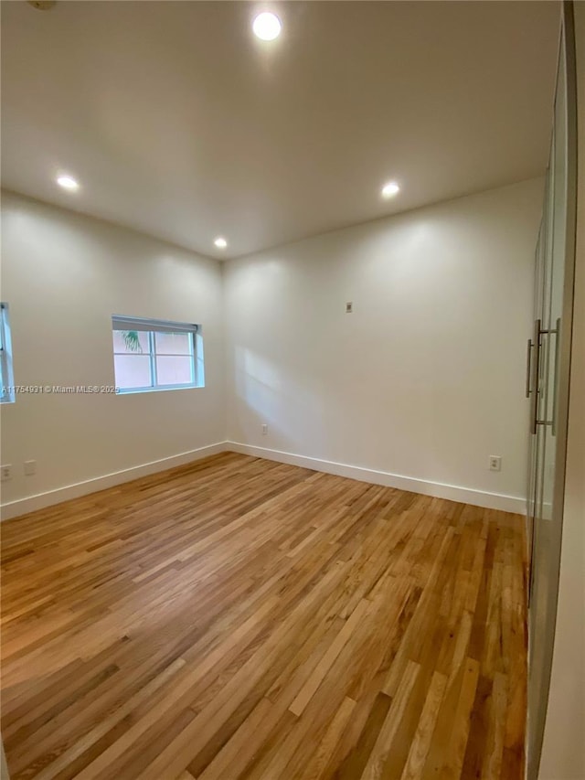 spare room featuring recessed lighting and light wood finished floors