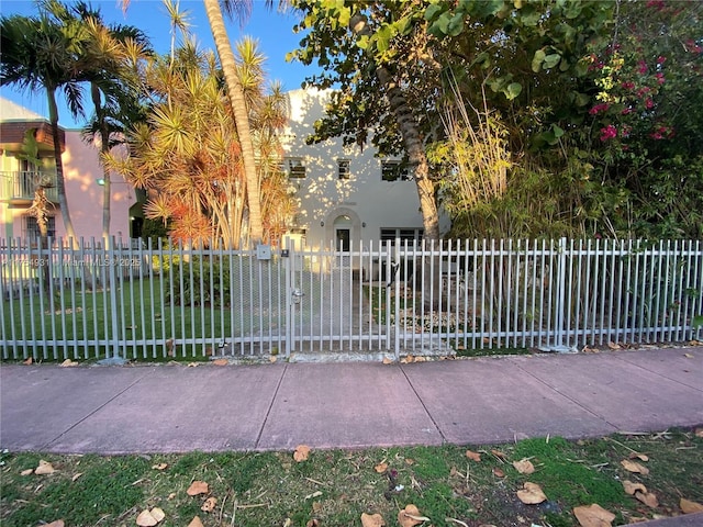 view of gate with a fenced front yard