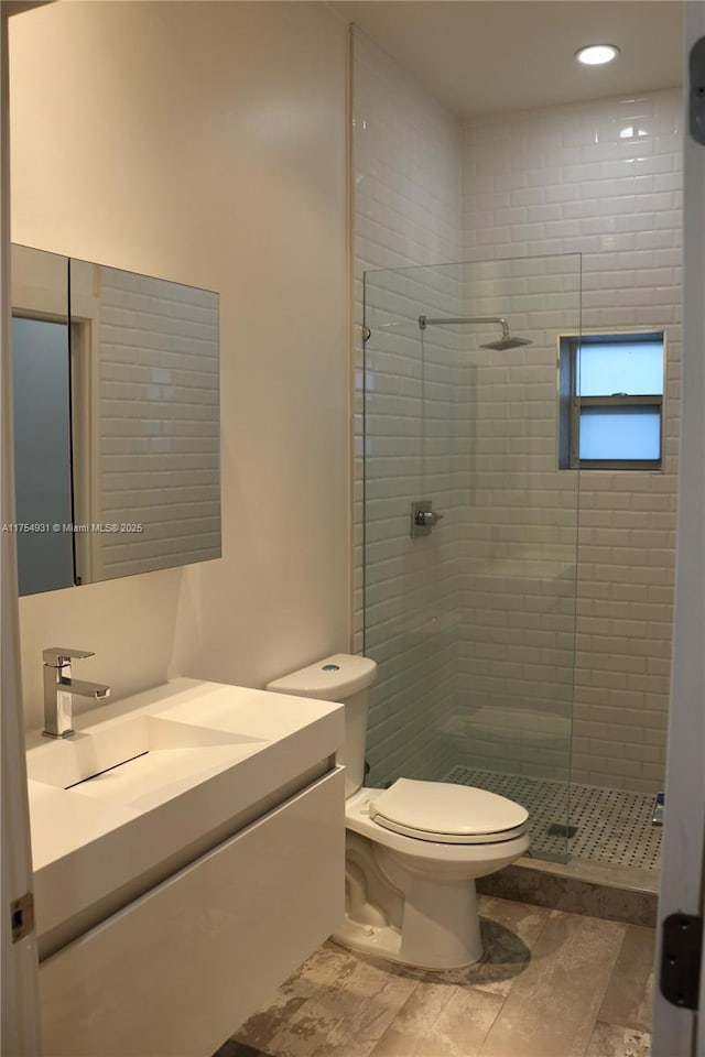 full bathroom with toilet, a stall shower, recessed lighting, and vanity