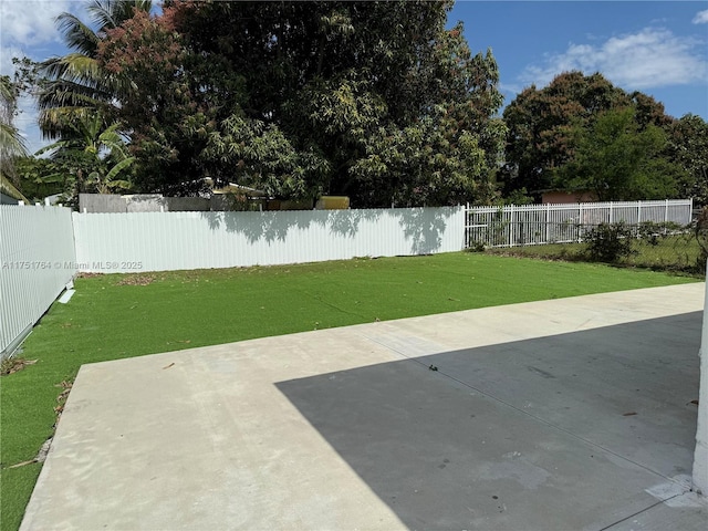 view of yard featuring a patio area and a fenced backyard