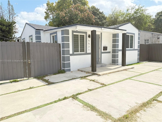 view of outdoor structure with fence and a porch