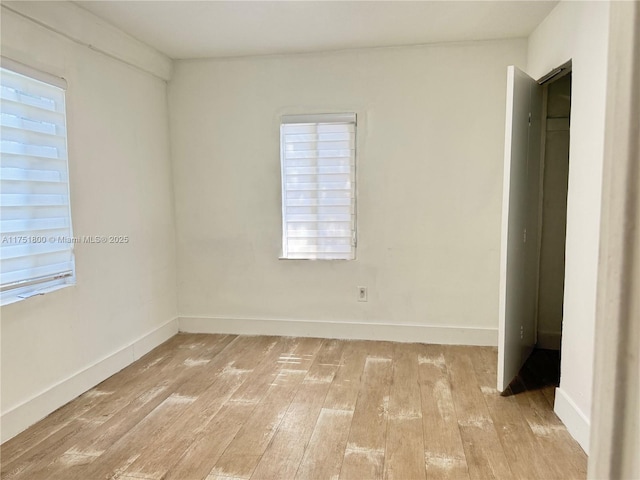 unfurnished bedroom with light wood-type flooring and baseboards