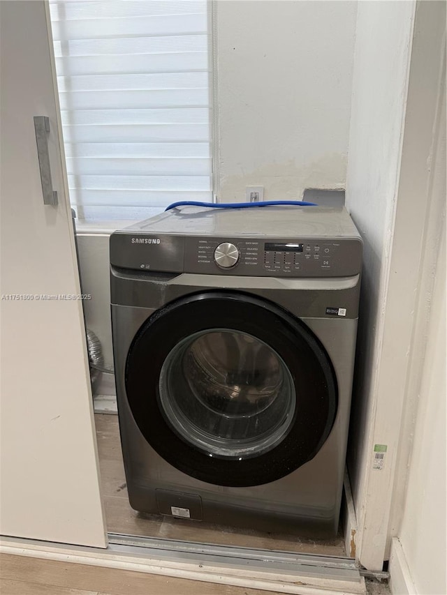 clothes washing area with washer / dryer and laundry area