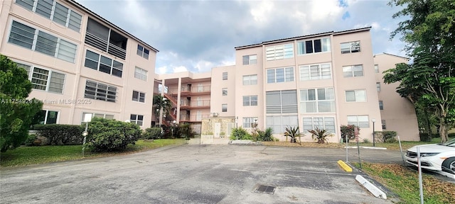 view of property featuring uncovered parking