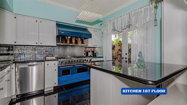 430 Poinciana Dr Unit 1710, Sunny Isles Beach, FL 33160 - kitchen with dark countertops, appliances with stainless steel finishes, ornamental molding, white cabinets, and wall chimney range hood