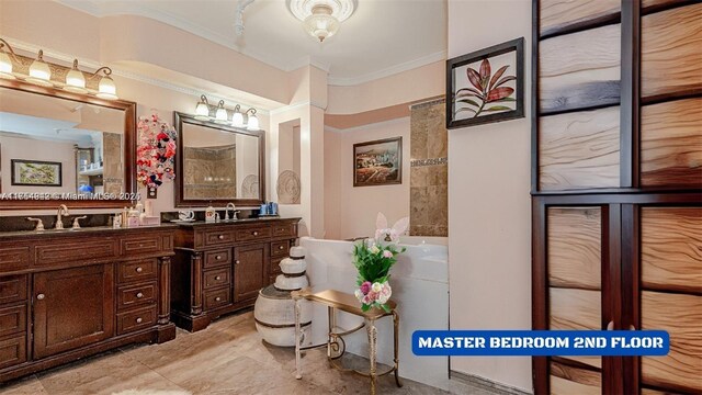 430 Poinciana Dr Unit 1710, Sunny Isles Beach, FL 33160 - bathroom featuring crown molding, double vanity, a sink, and a bath