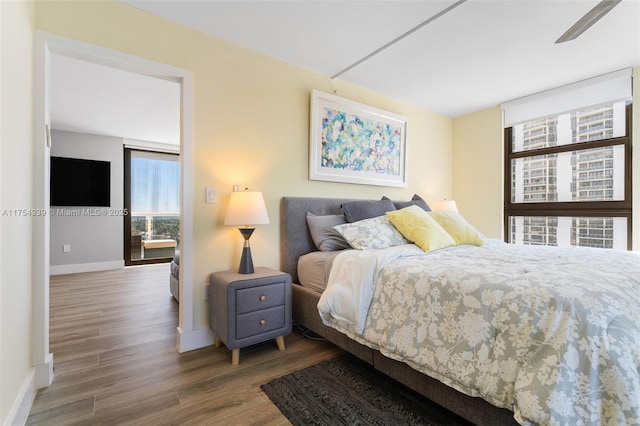 bedroom featuring wood finished floors and baseboards