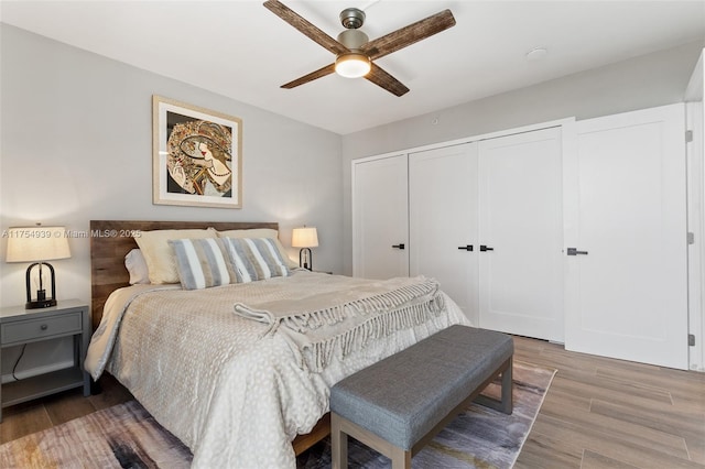 bedroom featuring ceiling fan, a closet, and wood finished floors