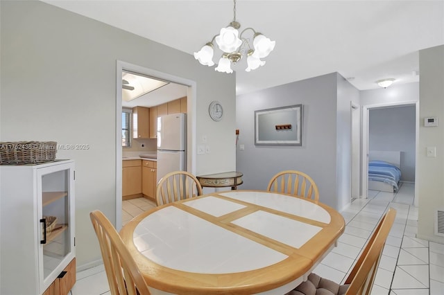2775 W Dudley Dr W Unit E, West Palm Beach, FL 33415 - dining area with a chandelier and light tile patterned flooring