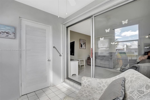 bedroom with ceiling fan and light tile patterned flooring