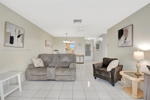 living area with light tile patterned floors, ceiling fan with notable chandelier, and visible vents