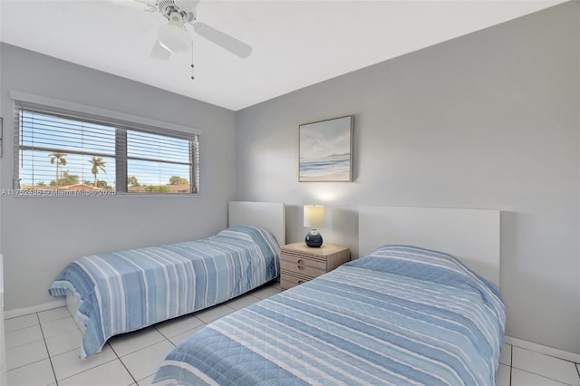 bedroom with light tile patterned floors, ceiling fan, and baseboards