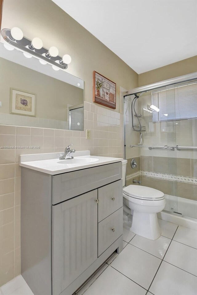2775 W Dudley Dr W Unit E, West Palm Beach, FL 33415 - bathroom with tile walls, tile patterned floors, vanity, and a shower stall