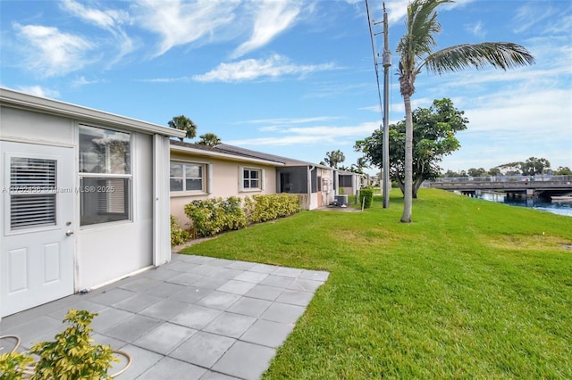 2775 W Dudley Dr W Unit E, West Palm Beach, FL 33415 - view of grassy yard with a water view and a patio area