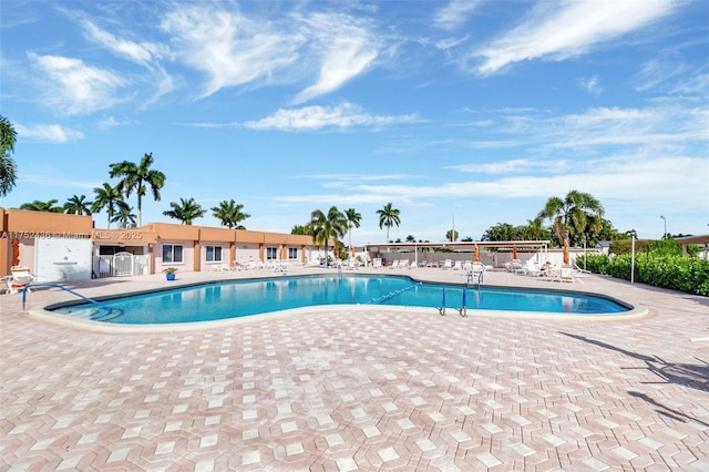 pool featuring a patio area and fence