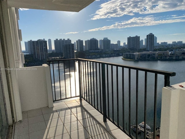 balcony featuring a view of city and a water view