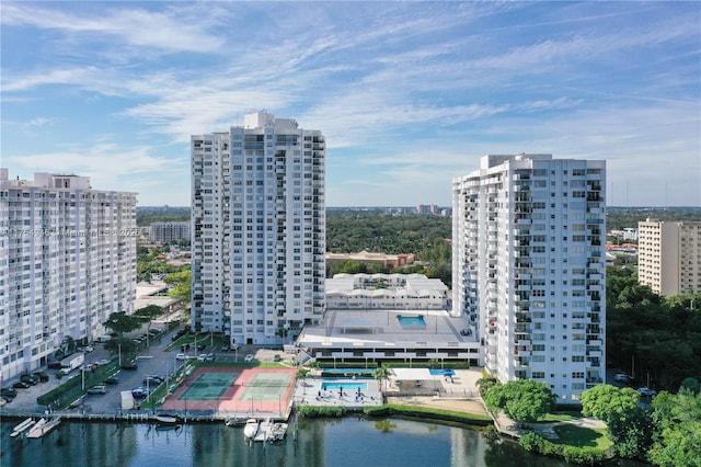 birds eye view of property with a water view and a view of city