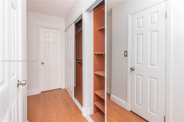 interior space with light wood finished floors and baseboards