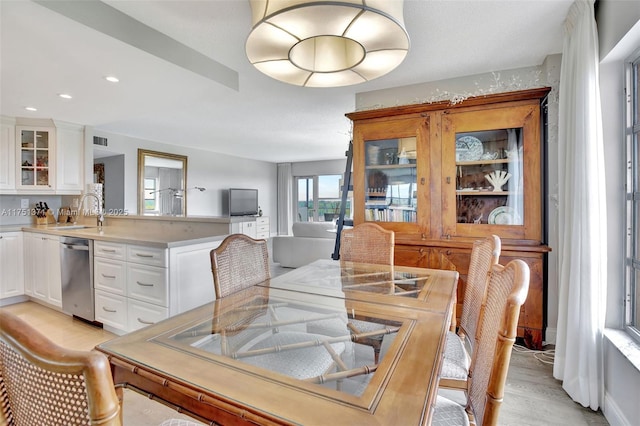 dining area with recessed lighting and light wood finished floors