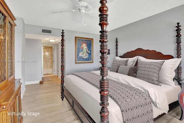 10777 W Sample Rd Unit 912, Coral Springs, FL 33065 - bedroom with light wood-type flooring, baseboards, a textured ceiling, ensuite bathroom, and a ceiling fan