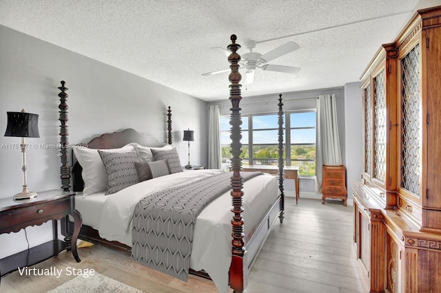 10777 W Sample Rd Unit 912, Coral Springs, FL 33065 - bedroom with light wood-type flooring, a textured ceiling, a ceiling fan, and baseboards