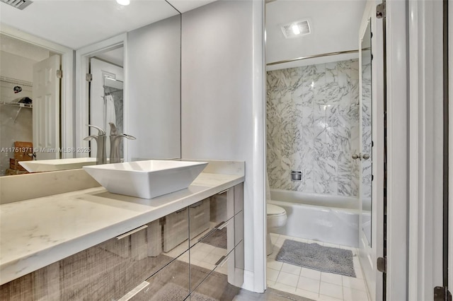 full bathroom with  shower combination, visible vents, vanity, and toilet